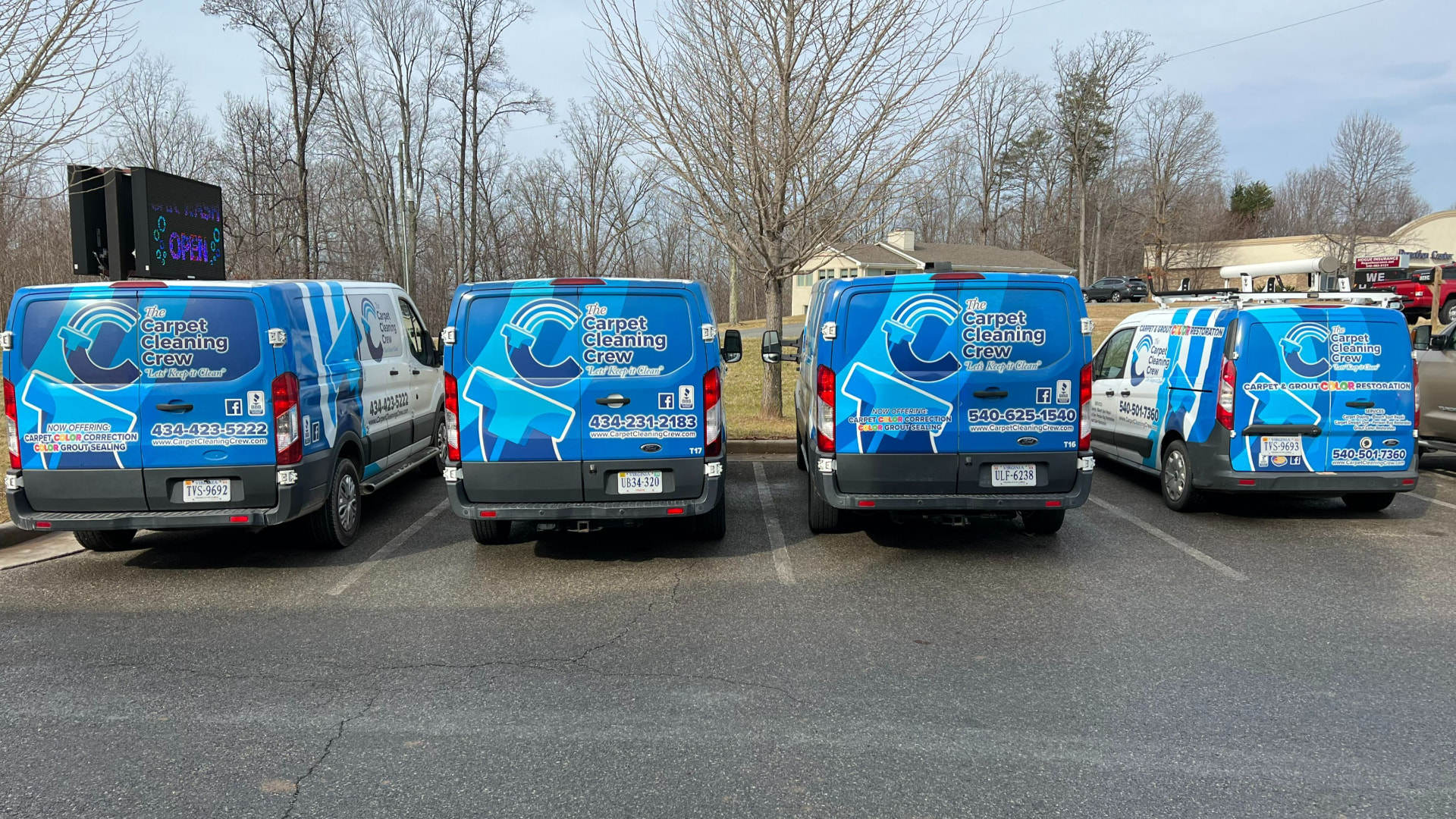 The Carpet Cleaning Crew's fleet of branded service vans parked on site